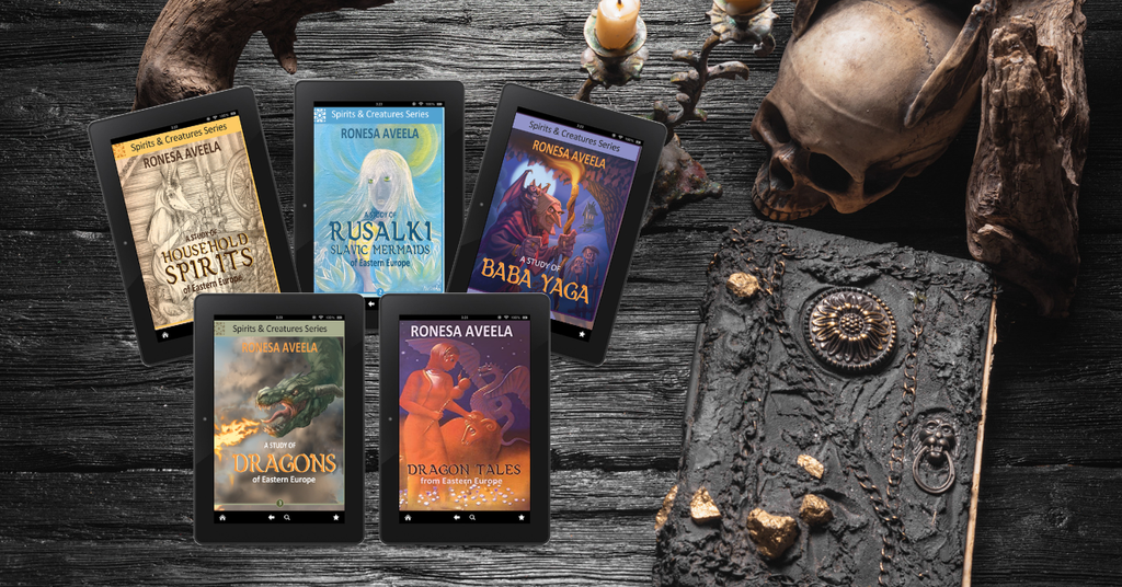 Spirits and Creatures ebooks on a dark wooden surface with an old book and decorative elements.