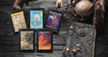 Spirits and Creatures ebooks on a dark wooden surface with an old book and decorative elements.